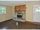 Inviting living room featuring a stone fireplace with a wooden mantle and natural light at 4675 N Herbemont Rd, Martinsville, IN 46151
