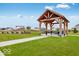 Community gazebo with picnic tables, surrounded by a park-like setting for outdoor gatherings and relaxation at 469 Hidden Hills Way, Pittsboro, IN 46167