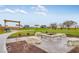 Outdoor community space featuring a fire pit with stone benches and landscaping for resident gatherings at 469 Hidden Hills Way, Pittsboro, IN 46167