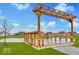 Scenic view of a covered gazebo overlooking a pond, perfect for relaxation and community gatherings at 469 Hidden Hills Way, Pittsboro, IN 46167