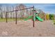 Community playground featuring swings and a green slide surrounded by a wood chip ground at 469 Hidden Hills Way, Pittsboro, IN 46167