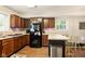 Practical kitchen with wood cabinets, countertop seating, and good natural light at 4701 Candy Spots Dr, Indianapolis, IN 46237