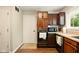 Traditional kitchen featuring wood cabinets, a practical layout, and updated flooring at 4701 Candy Spots Dr, Indianapolis, IN 46237