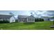 Spacious backyard with lush lawn and chairs and trees and houses on either side at 4960 Silverbell Dr, Plainfield, IN 46168