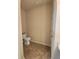 Compact half bath with toilet, tile floor, toilet paper, door and base-molding at 4960 Silverbell Dr, Plainfield, IN 46168