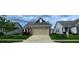 An exterior view shows the house with a well-kept lawn, a brick and siding design, and manicured landscaping at 4960 Silverbell Dr, Plainfield, IN 46168
