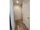 Hallway with wood-look floors, neutral walls, and access to multiple rooms at 4960 Silverbell Dr, Plainfield, IN 46168