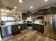 Modern kitchen with stainless steel appliances, dark cabinetry, and spacious countertops at 4960 Silverbell Dr, Plainfield, IN 46168