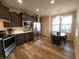 Bright eat-in kitchen with stainless steel appliances, dark cabinets, and a dining table near the window at 4960 Silverbell Dr, Plainfield, IN 46168