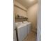 Functional laundry room features a stacked washer and dryer, plus convenient shelving for storage at 4960 Silverbell Dr, Plainfield, IN 46168