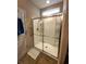 Shower features clear sliding glass door, shower head and tiled walls at 4960 Silverbell Dr, Plainfield, IN 46168