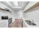 Well-lit kitchen with white cabinets, quartz counters, and wood-style flooring at 5097 Vantage Point Rd # B 2, Avon, IN 46123