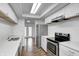Bright kitchen featuring white cabinets, stainless steel appliances, and wood grain floors at 5097 Vantage Point Rd # B 2, Avon, IN 46123