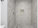 Updated shower with marble surround, mosaic tile floor, and inset soap niche at 5097 Vantage Point Rd # B 2, Avon, IN 46123