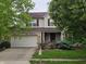 Charming two-story home featuring a two-car garage, inviting front porch, and beautifully landscaped front yard at 5305 Potomac Ln, Greenwood, IN 46142