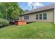 Exterior of home features a deck with hot tub perfect for relaxing in the backyard at 5640 High Vista Cir, Indianapolis, IN 46234