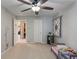 Neutral bedroom features ceiling fan and view to the ensuite bathroom and walk in closet at 5640 High Vista Cir, Indianapolis, IN 46234