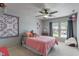 Bright bedroom with plush pillows, ceiling fan, and decorative wall art at 5640 High Vista Cir, Indianapolis, IN 46234