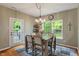 Bright dining area features a modern chandelier, backyard views, and access to the back patio at 5640 High Vista Cir, Indianapolis, IN 46234