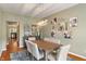 Dining room featuring stylish decor, a wood table, and a view into the adjacent kitchen at 5640 High Vista Cir, Indianapolis, IN 46234