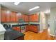 Kitchen featuring wood cabinets, granite countertops, stainless steel appliances, and hardwood floors at 5640 High Vista Cir, Indianapolis, IN 46234