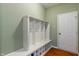 A practical mudroom with custom shelving and a bench, adjacent to a door leading outside at 5640 High Vista Cir, Indianapolis, IN 46234