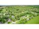 Lovely aerial view featuring mature trees, a tranquil lake, and peaceful neighborhood at 5739 Paradise Dr, Martinsville, IN 46151