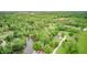 Picturesque aerial captures the home's setting amidst lush trees and serene lake views at 5739 Paradise Dr, Martinsville, IN 46151