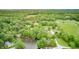Breathtaking aerial showcases the home nestled among mature trees with views of the lake at 5739 Paradise Dr, Martinsville, IN 46151