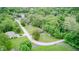 A beautiful aerial view of a home surrounded by lush trees in a serene neighborhood near a lake at 5739 Paradise Dr, Martinsville, IN 46151