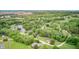 Aerial view of the home and surrounding area highlighting mature trees and a nearby lake at 5739 Paradise Dr, Martinsville, IN 46151
