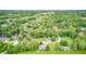 Stunning aerial showing the home, surrounding trees, a tranquil lake, and a peaceful neighborhood at 5739 Paradise Dr, Martinsville, IN 46151