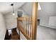 View of the finished attic with wood railing, skylight, and whitewashed wood walls and neutral carpet at 5739 Paradise Dr, Martinsville, IN 46151