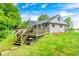 Backyard view of home featuring a wooden deck and lush green lawn at 5739 Paradise Dr, Martinsville, IN 46151