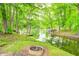 Lake view lot with lush green trees, multiple docks and an elevated fire pit at 5739 Paradise Dr, Martinsville, IN 46151