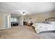 Large bedroom showing en-suite bathroom, neutral carpet, fan, and sitting area with sofa at 5739 Paradise Dr, Martinsville, IN 46151