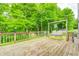Relaxing wooden deck with a charming swing and beautiful foliage at 5739 Paradise Dr, Martinsville, IN 46151