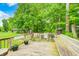 Wood deck with bench and view of the lake surrounded by lush trees at 5739 Paradise Dr, Martinsville, IN 46151