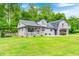Charming home exterior with a well-maintained lawn, lush landscaping, and a two-story design at 5739 Paradise Dr, Martinsville, IN 46151