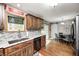 Kitchen featuring granite countertops, stainless dishwasher, and sliding barn door at 5739 Paradise Dr, Martinsville, IN 46151