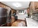 Bright kitchen boasts stainless steel appliances and beautiful wood cabinetry and floors at 5739 Paradise Dr, Martinsville, IN 46151