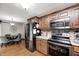 Open-concept kitchen, stainless appliances, and a breakfast nook with gray upholstered chairs at 5739 Paradise Dr, Martinsville, IN 46151
