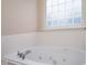 Bathroom features a soaking tub beneath a glass block window at 6105 Franklin Villas Way, Indianapolis, IN 46237