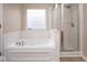 Bathroom features a soaking tub and shower with glass enclosure at 6105 Franklin Villas Way, Indianapolis, IN 46237