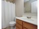 Bathroom vanity with single sink, white toilet and shower with curtain at 6105 Franklin Villas Way, Indianapolis, IN 46237
