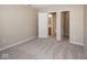 This bedroom features neutral carpeting and walls, with doorways leading to the bathroom and closet at 6105 Franklin Villas Way, Indianapolis, IN 46237
