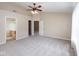 Spacious bedroom features neutral walls, carpet, and ceiling fan fixture at 6105 Franklin Villas Way, Indianapolis, IN 46237
