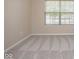 An interior shot shows a bedroom with a large window providing natural light and neutral decor throughout at 6105 Franklin Villas Way, Indianapolis, IN 46237