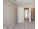 A well-lit bedroom shows an open doorway leading to a hallway and closet, with neutral walls and carpet at 6105 Franklin Villas Way, Indianapolis, IN 46237