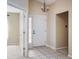 Welcoming foyer with tile flooring, a classic chandelier, and easy access to other rooms at 6105 Franklin Villas Way, Indianapolis, IN 46237